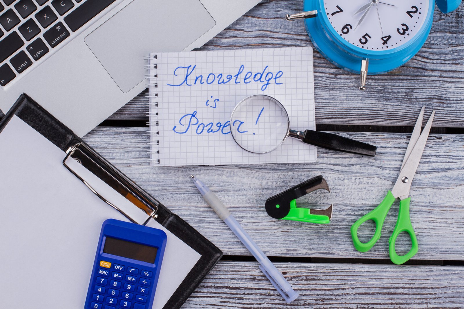 Studying accessories and knowledge is power slogan. Top view flat lay.